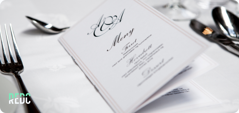 A formal place setting and menu.