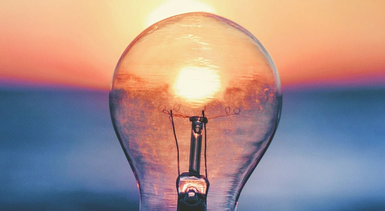 Light bulb with sunset behind